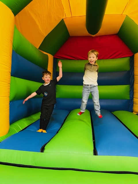 Boys bouncing on a bouncy castle in Telford